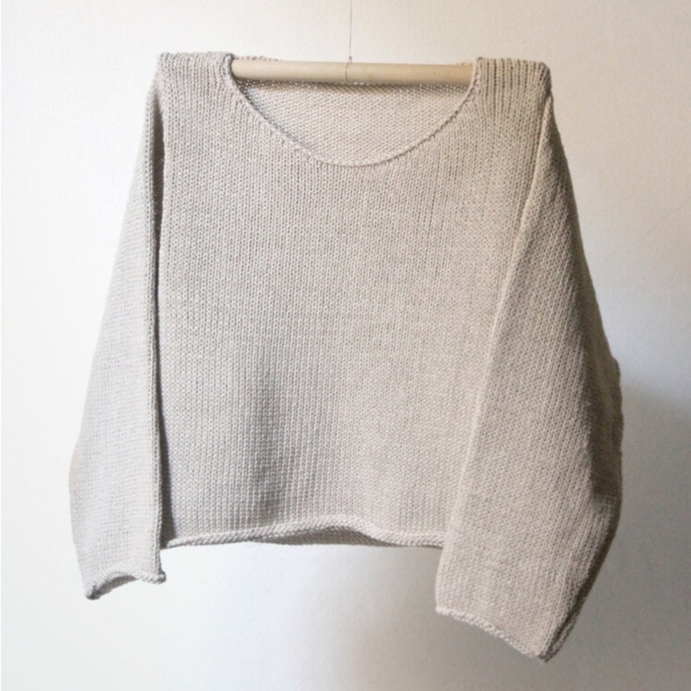 Cropped 100% cotton, hand-knit sweater by Nido in the color “Ecru” (cream).